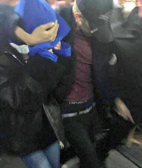 权志龙在走出店外时,紧搂着一名女子冲过重重包围